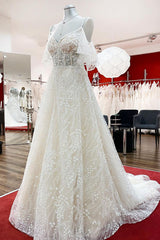 Elegant Sweetheart Tulle Wedding Dress with Long A-line Sleeves and Lace Appliques