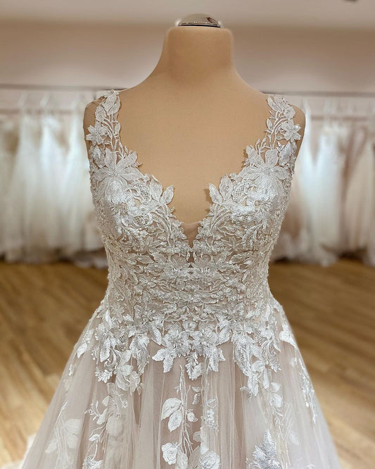 Elegant Deep V-neck A-Line Wedding Gown with Spaghetti Straps, Ruffles, and Lace Appliques on Tulle