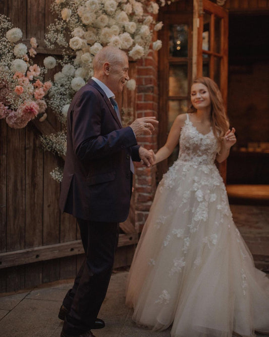 Elegant V-neck A-line Tulle Wedding Dress with Backless Design and Lace Appliques
