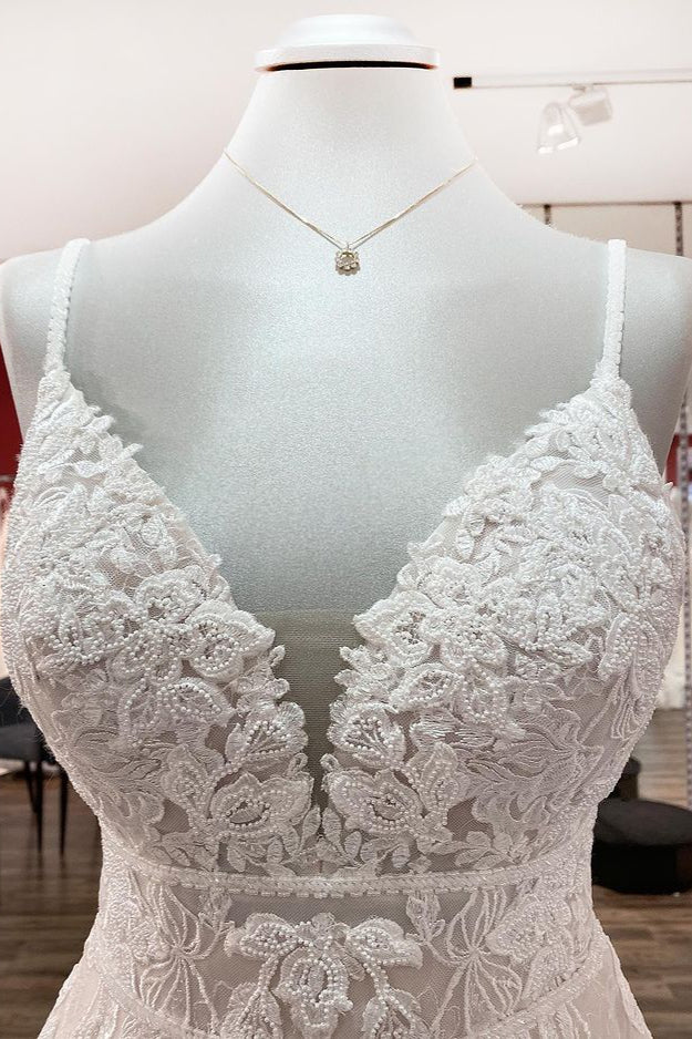 V-neck sleeveless A-line tulle wedding dress with backless design, lace appliques, and ruffles