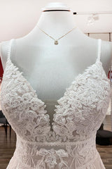 V-neck sleeveless A-line tulle wedding dress with backless design, lace appliques, and ruffles