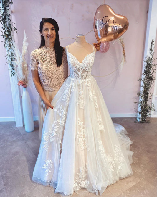 Elegant A-Line Wedding Dress with Spaghetti Straps, Floor-length Train, and Lace Appliques