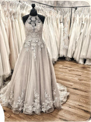 Elegant Backless Halter Wedding Dress with Lace Appliques and Tulle Ruffles