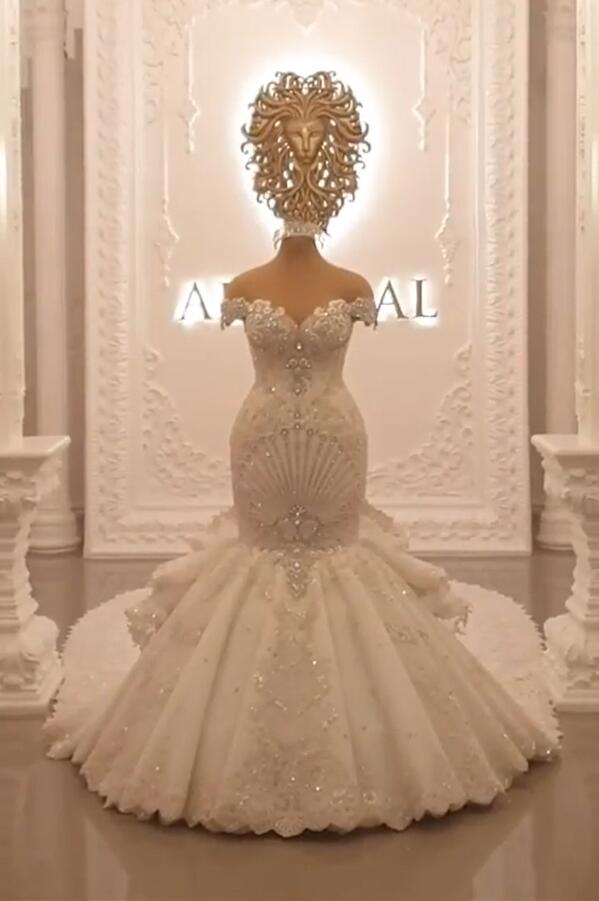 Elegant Off-The-Shoulder Mermaid Wedding Dress with Crystal Details and Backless Design