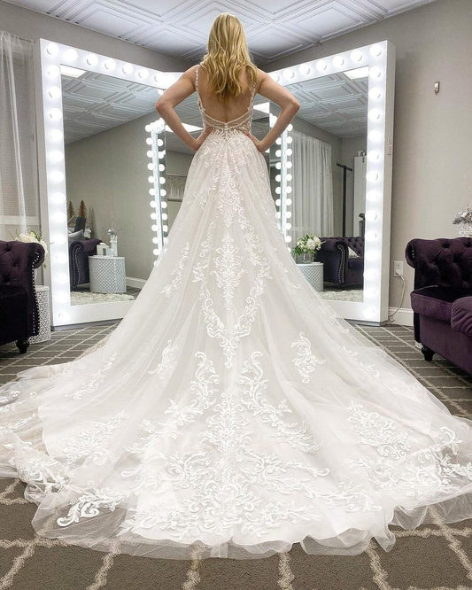 Elegant A-line Wedding Gown with Spaghetti Straps, Deep V-neck, and Lace Appliques on Tulle