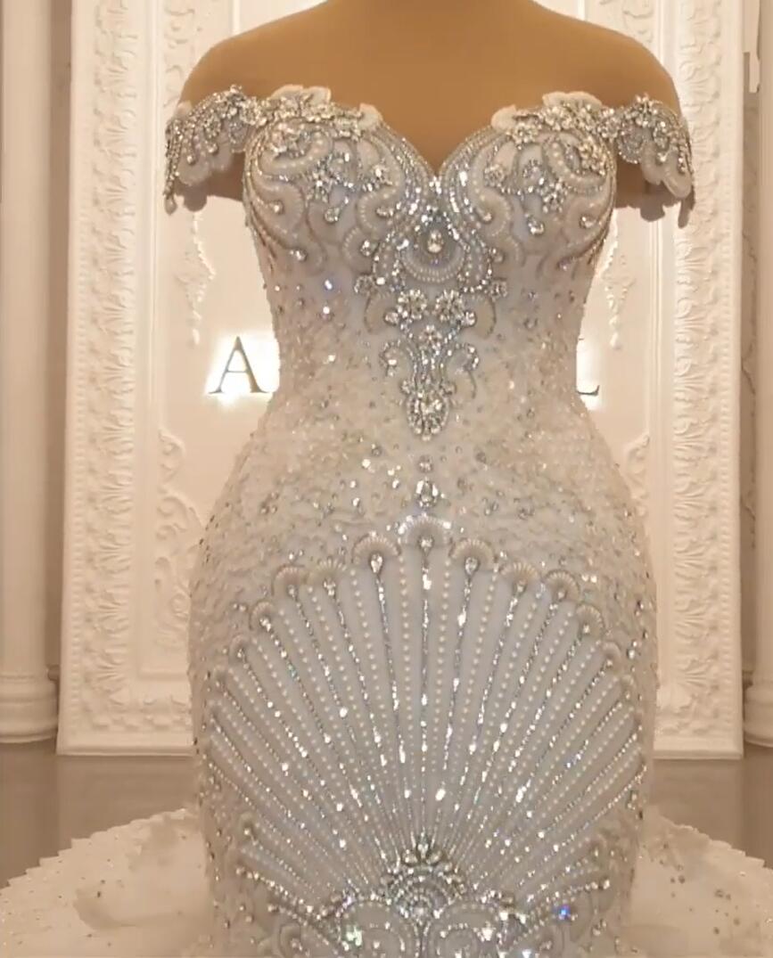 Elegant Off-The-Shoulder Mermaid Wedding Dress with Crystal Details and Backless Design