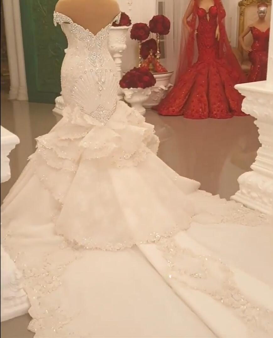 Elegant Off-The-Shoulder Mermaid Wedding Dress with Crystal Details and Backless Design