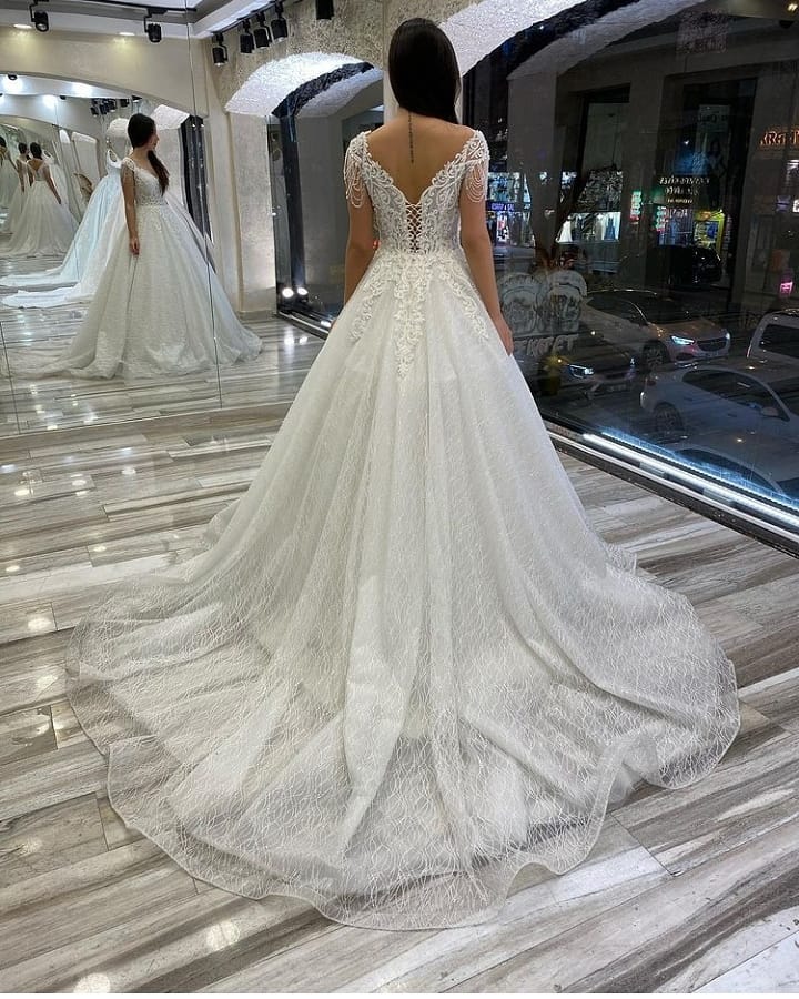 Elegant Sweetheart Backless A-Line Wedding Gown with Sequins, Appliques, and Lace Train