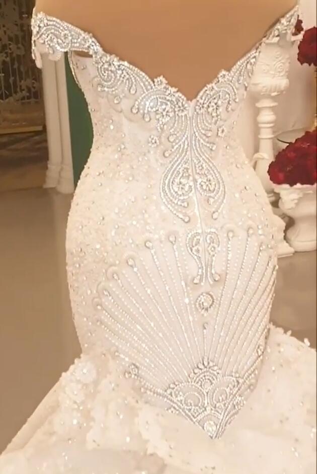 Elegant Off-The-Shoulder Mermaid Wedding Dress with Crystal Details and Backless Design