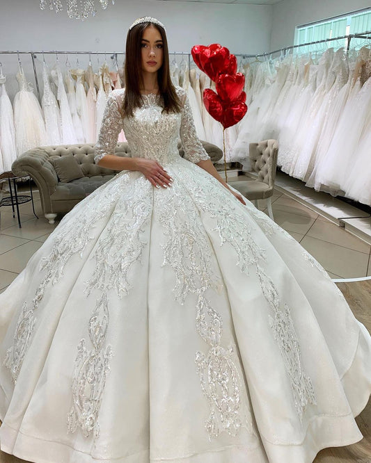 Elegant Satin Princess Bateau Wedding Gown with Long Sleeves and Lace Appliques