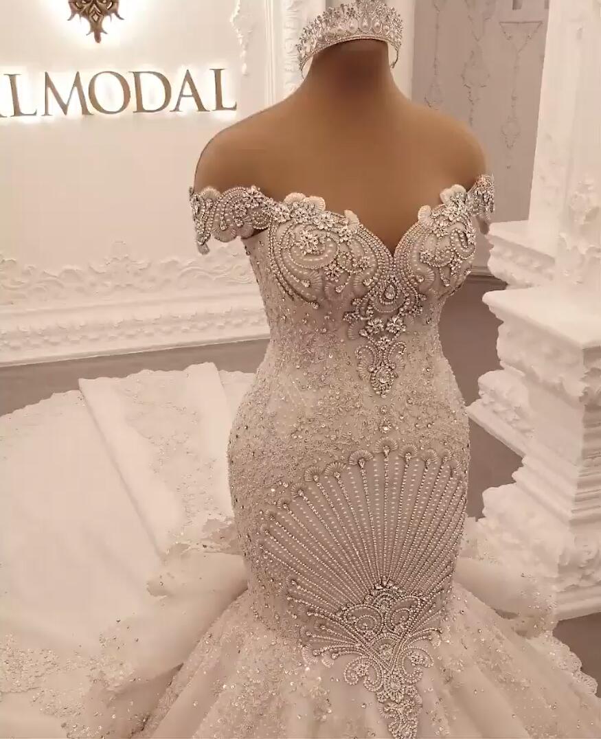 Elegant Off-The-Shoulder Mermaid Wedding Dress with Crystal Details and Backless Design