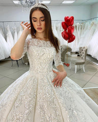 Elegant Satin Princess Bateau Wedding Gown with Long Sleeves and Lace Appliques