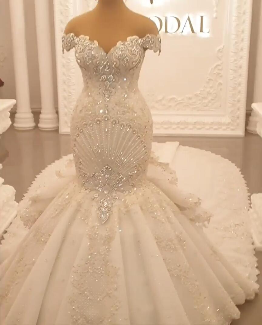 Elegant Off-The-Shoulder Mermaid Wedding Dress with Crystal Details and Backless Design