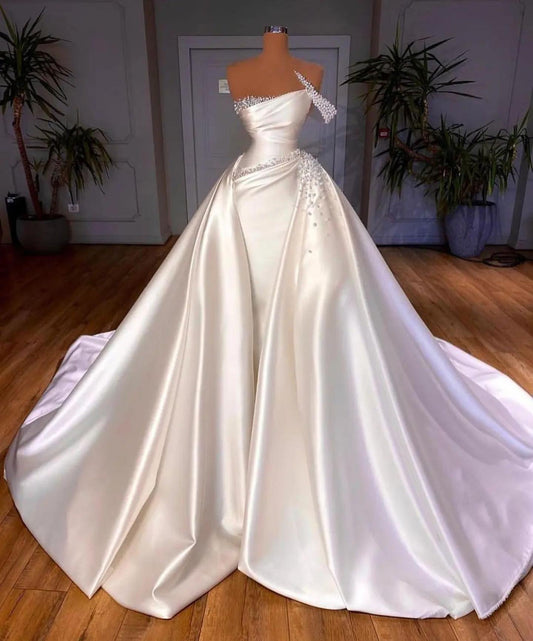 Elegant White Mermaid Bridal Gown with One Shoulder and Pearl-Adorned Detachable Skirt