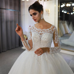 Sophisticated Floor-length A-Line Wedding Gown with Bateau Neckline, Long Sleeves, and Lace Appliques Sequins