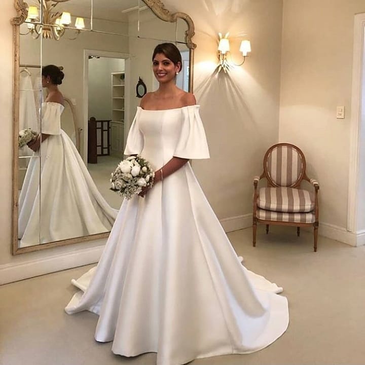 Elegant Off-the-Shoulder Short Sleeve A-Line Bridal Gown Featuring Satin Ruffles and a Train