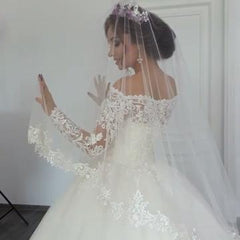 Elegant Off-the-Shoulder Ball Gown with Long Sleeves and Lace Appliques