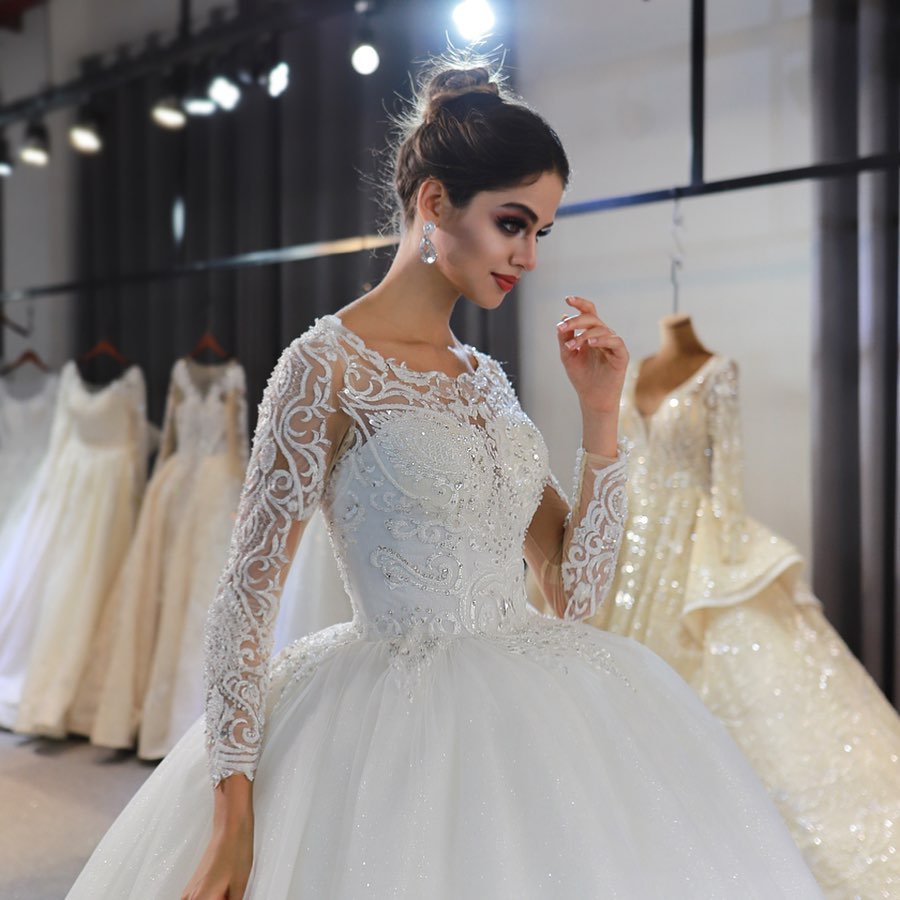 Sophisticated Floor-length A-Line Wedding Gown with Bateau Neckline, Long Sleeves, and Lace Appliques Sequins