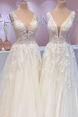 Contemporary A-Line Wedding Gown with Open Back, Lace Train, and Wide Straps Featuring Tulle Appliques