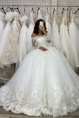 Elegant Off-The-Shoulder Illusion Ball Gown Wedding Dress with Long Sleeves and Appliques