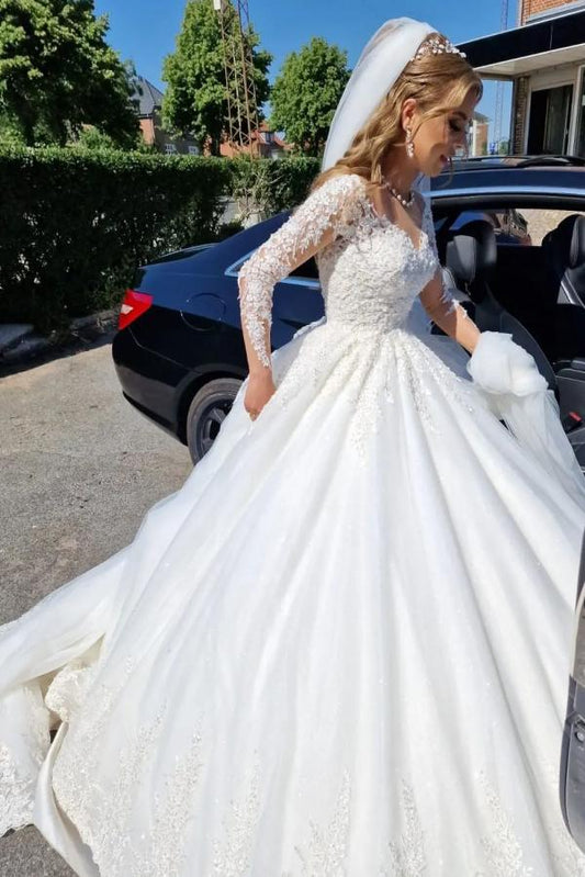 Elegant white lace wedding dress featuring a V-neck and long sleeves in an A-line silhouette