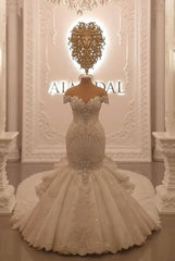 Elegant Off-The-Shoulder Mermaid Wedding Dress with Crystal Details and Backless Design