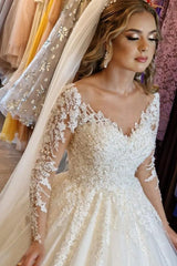 Elegant white lace wedding dress featuring a V-neck and long sleeves in an A-line silhouette