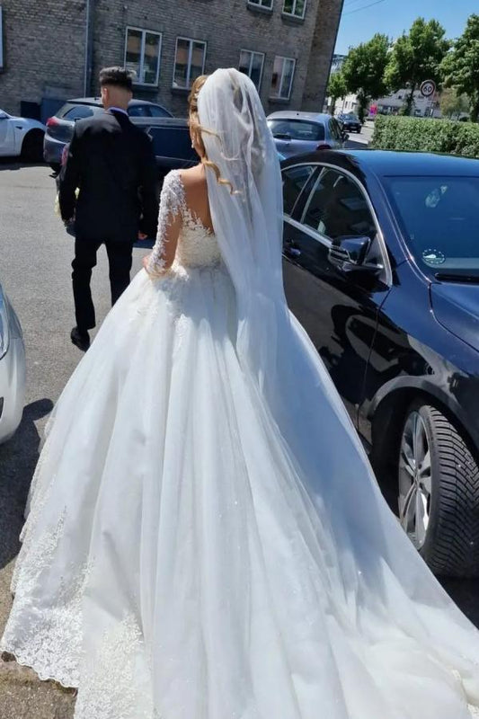 Elegant white lace wedding dress featuring a V-neck and long sleeves in an A-line silhouette