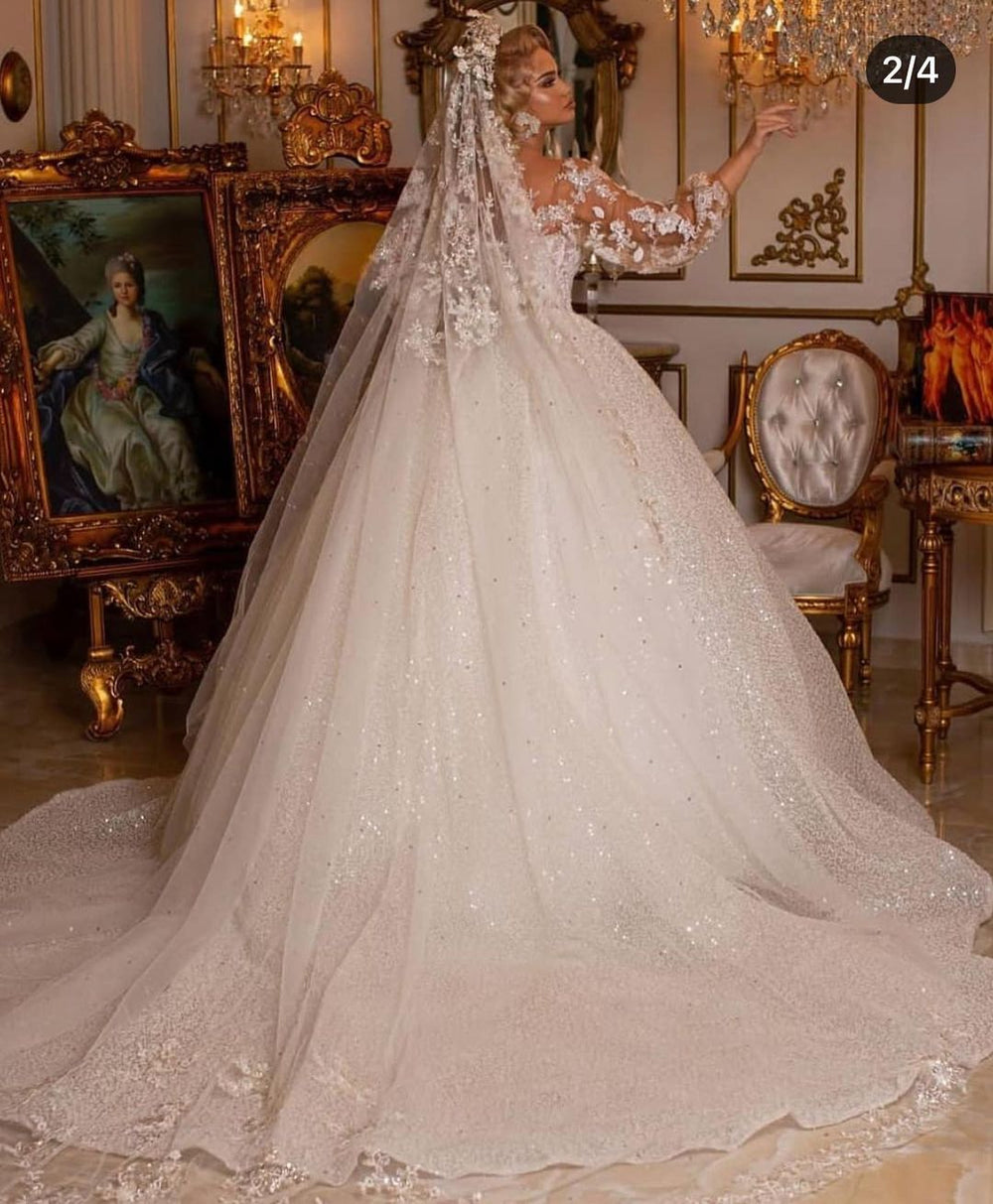 Elegant Ball Gown Wedding Dress Featuring Long Puffy Sleeves and Appliques
