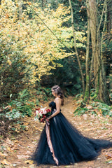 Elegant strapless black A-line wedding gown with lace appliques and tulle