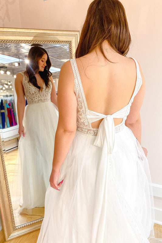 Contemporary A-Line Wedding Gown with Deep V-Neck, Spaghetti Straps, and Tulle Train