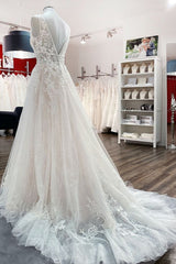 Sleeveless A-line Wedding Dress in Tulle with Elegant Deep V-neck and Open Back Lace Appliques