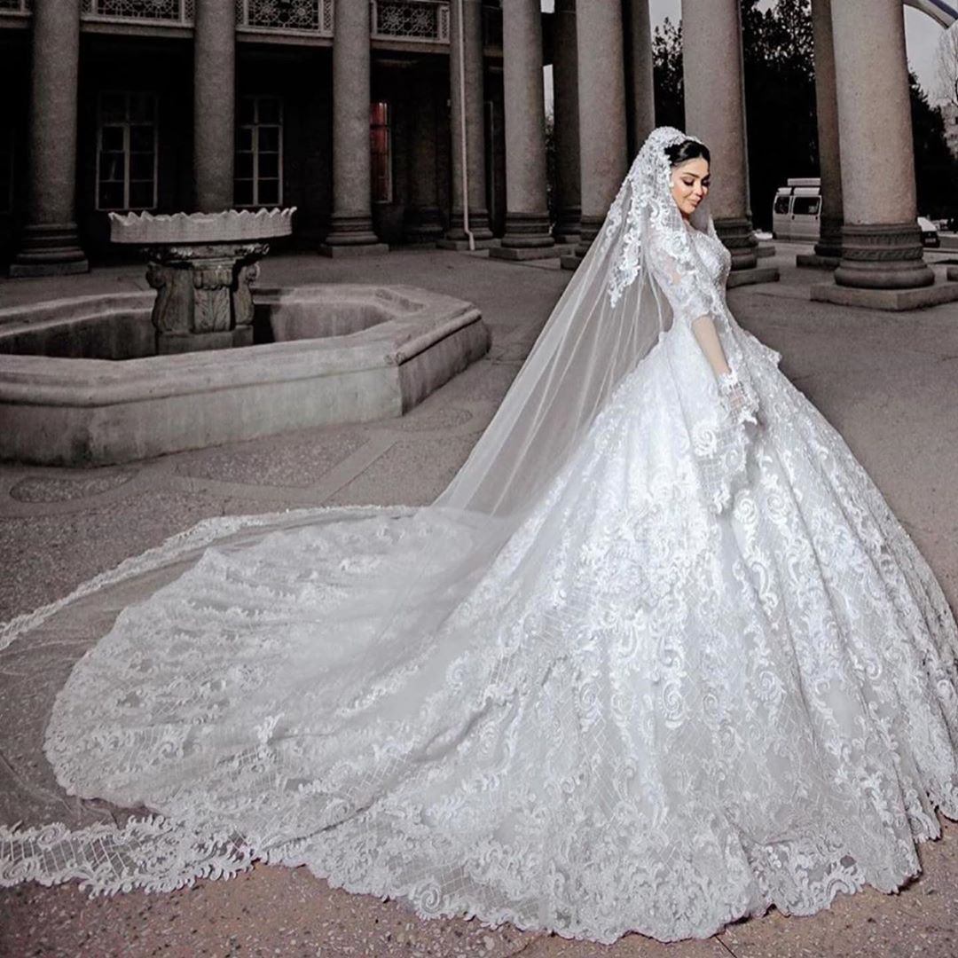 Elegant Princess Wedding Gown with Chic Bead Appliques and Long Sleeves in Tulle