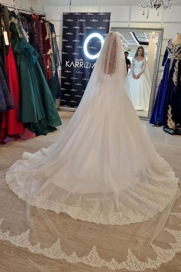 Elegant white lace wedding dress featuring a V-neck and long sleeves in an A-line silhouette