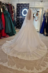 Elegant white lace wedding dress featuring a V-neck and long sleeves in an A-line silhouette