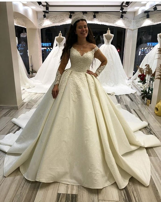 Elegant Sweetheart Princess Wedding Gown with Long Satin Sleeves and Appliques