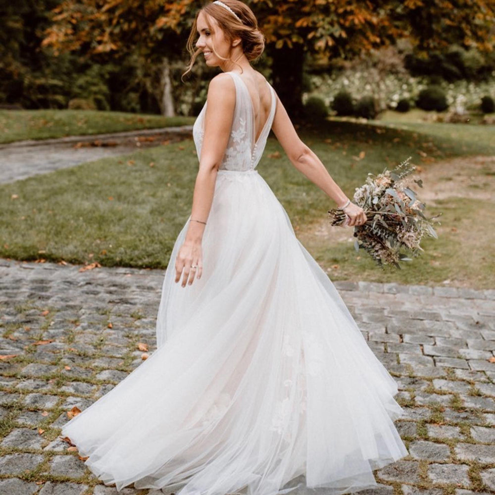 Elegant Floral A-Line Wedding Dress with Deep V-neck and Open Back