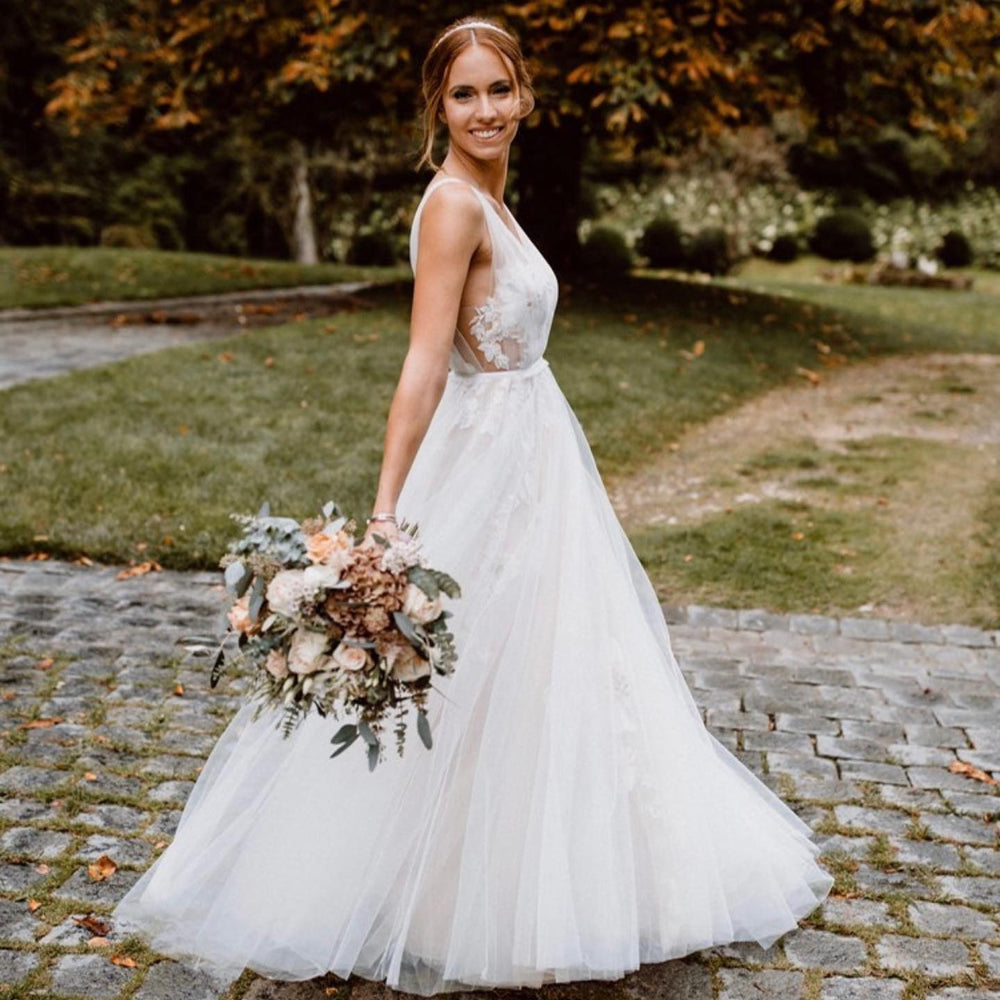 Elegant Floral A-Line Wedding Dress with Deep V-neck and Open Back